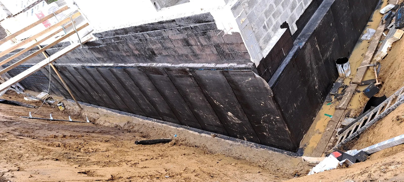 Murs de fondation recouverts de membrane d’étanchéité, vue d’ensemble du chantier, Andenne