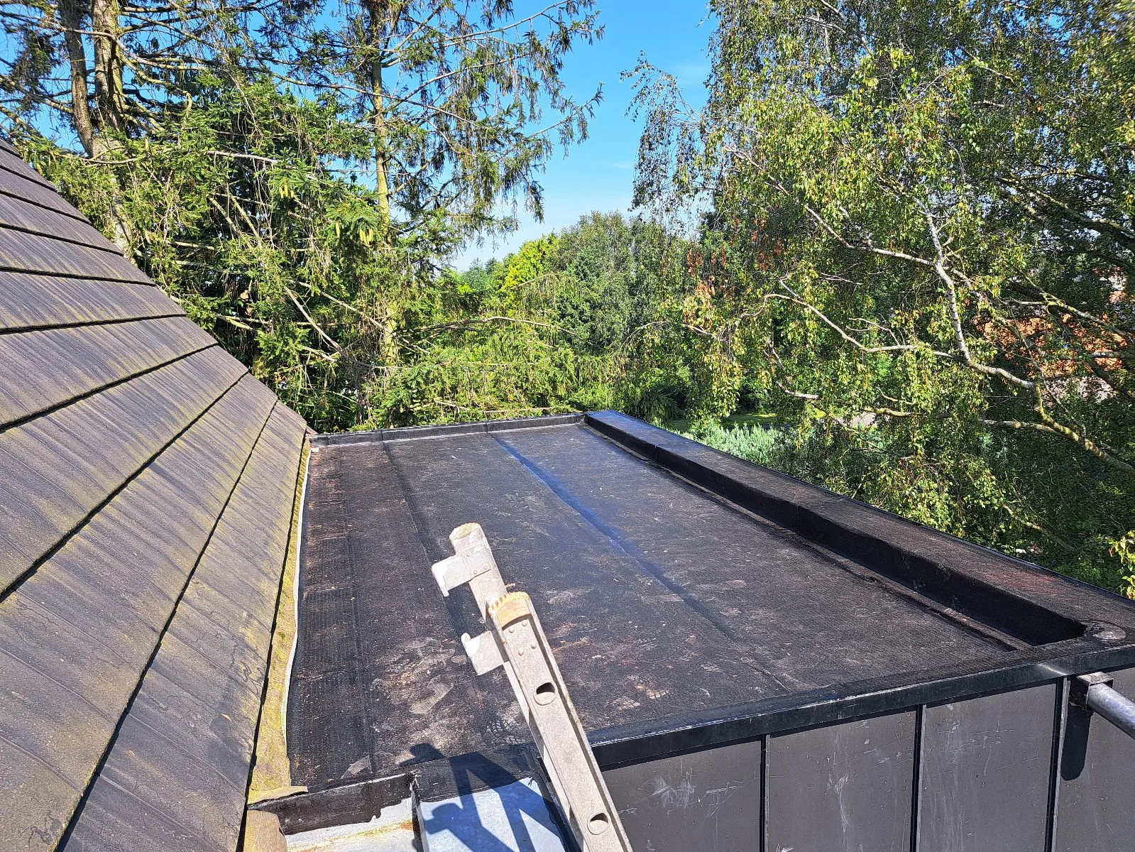 Toiture plate en membrane EPDM noire neuve jouxtant un pan de toiture en ardoises, Floreffe